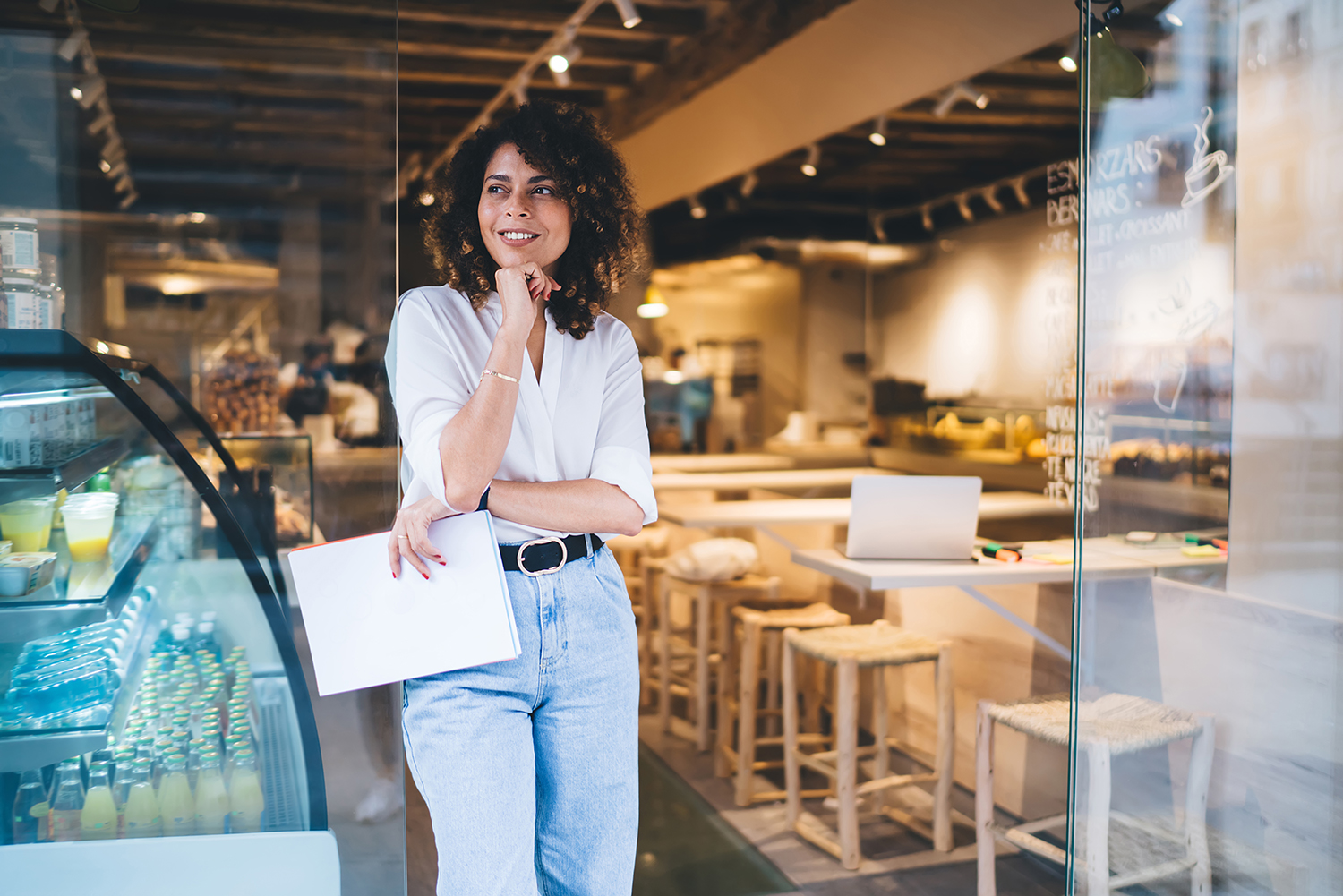 Optimistic female owner inside a coffee shop